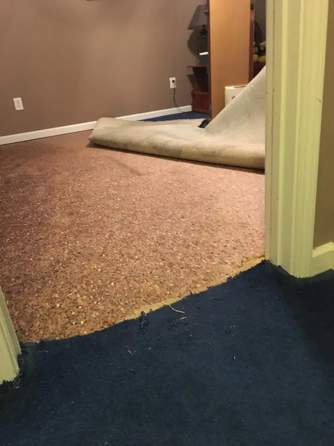 Carpet pad removal revealing water damage during Drying & Dehumidification in Brenham